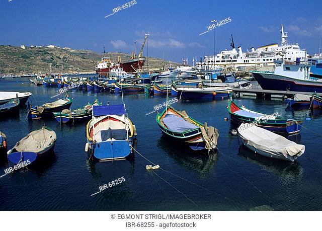 Luzzu boats in the harbour of Mgarr, Gozo island, Malta