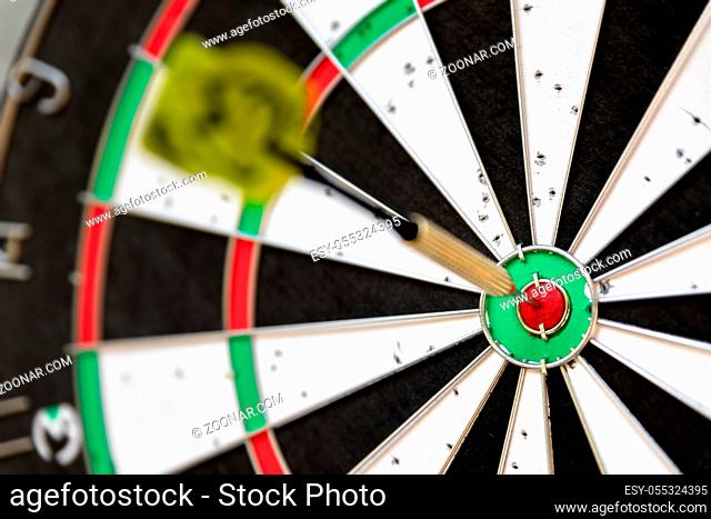 An image of a typical darts game with dart in the bullseye