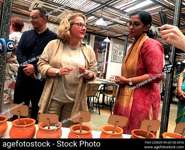 09 June 2023, India, Neu Delhi: Development Minister Svenja Schulze (SPD, M) is shown different types of millet during her visit to India in the Indian capital...
