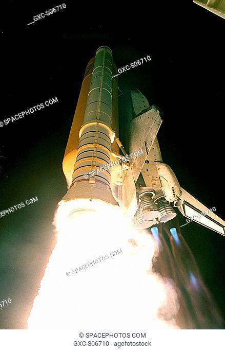 10/11/2000 -- Space Shuttle Discovery roars through the sky trailing fire and blue mach diamonds from the engines. The perfect on-time liftoff at 7:17 p