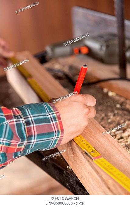Man measuring a piece of wood
