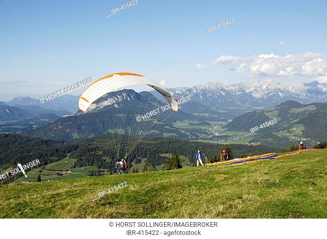Paraglider lifting off from the top of a mountain close to the Inn valley, Wildschoenau Tyrolian Alps, Austria