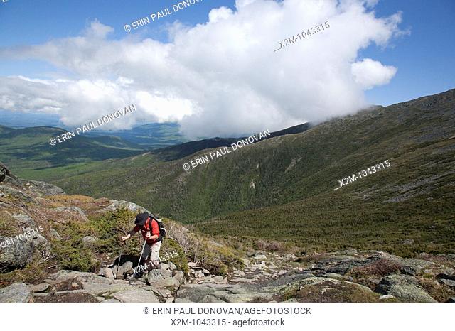 A hiker ascending Ammonoosuc Ravine Trail during the summer months  Located in the White Mountains, New Hampshire USA