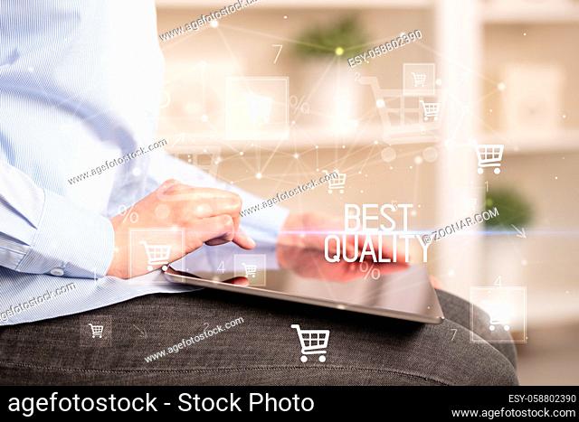 Young person makes a purchase through online shopping application with BEST QUALITY inscription