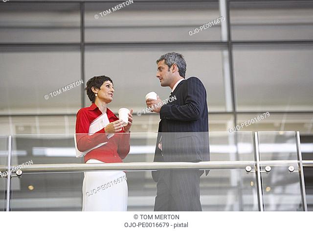 Low angle view of businessman and businesswoman with document