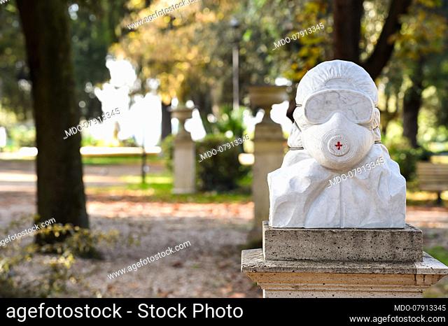 Anti Covid Soldiers bust. The white marble statue, located inside the Pincio gardens, depicts a person wearing overalls, goggles and anti Covid mask