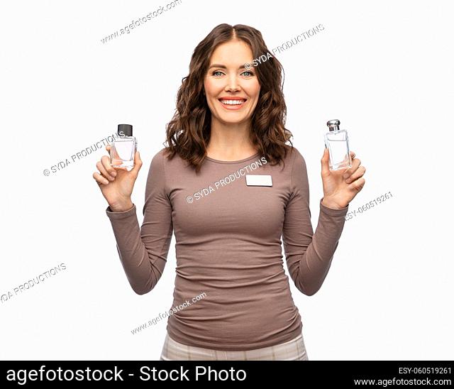 happy female shop assistant with perfume