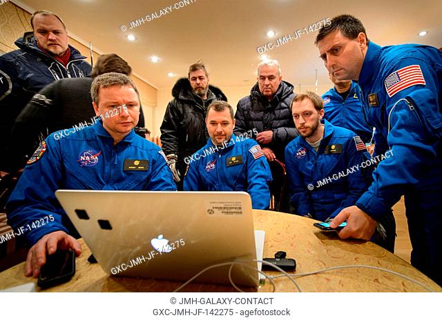 Members of NASA and the Russian support teams, that were unable to fly to the soyuz TMA-17M landing site due to weather, watch a live video stream of Expedition...