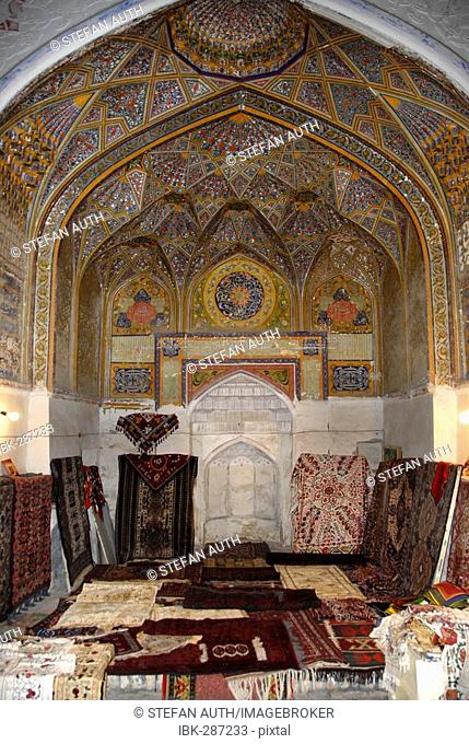 Decorated arch with mihrab now shop selling suzani and carpets in Khanaka Nadir Divan-Begi Lyab-i Hauz Bukhara Uzbekistan