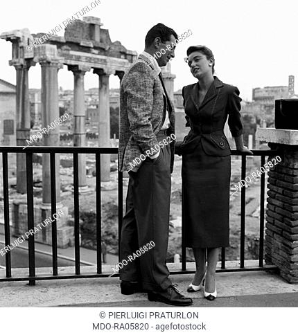 American singer and actor Dean Martin (Dino Paul Crocetti) and Italian actress Anna Maria Alberghetti in front of the Roman Forum on the set of the film Ten...