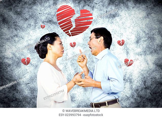 Older asian couple having an argument against red heart