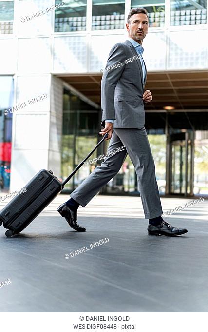 Businessman with baggage on the go