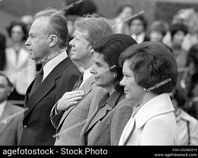 United States President Jimmy Carter, left center, listens to the National Anthem as he and first lady Rosalynn Carter, right