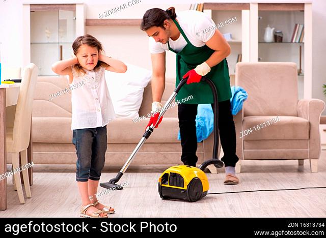Young contractor cleaning the house with his small daughter
