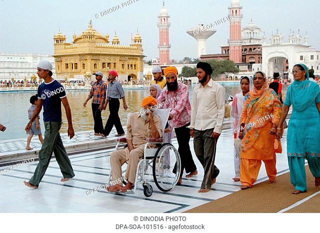 Sikh devotees walks around Golden temple ; Amritsar ; Punjab ; India