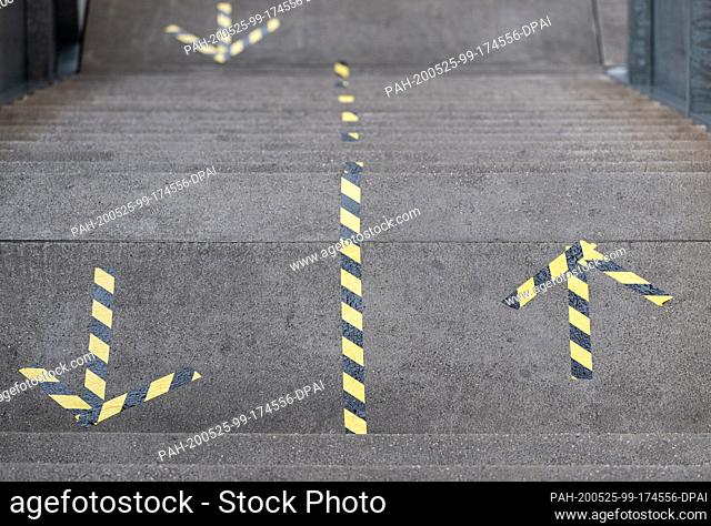 22 May 2020, Saxony, Dresden: Arrows indicating the direction of movement to maintain distances can be seen on the stairs in the Ufa-Kristallpalast cinema in...