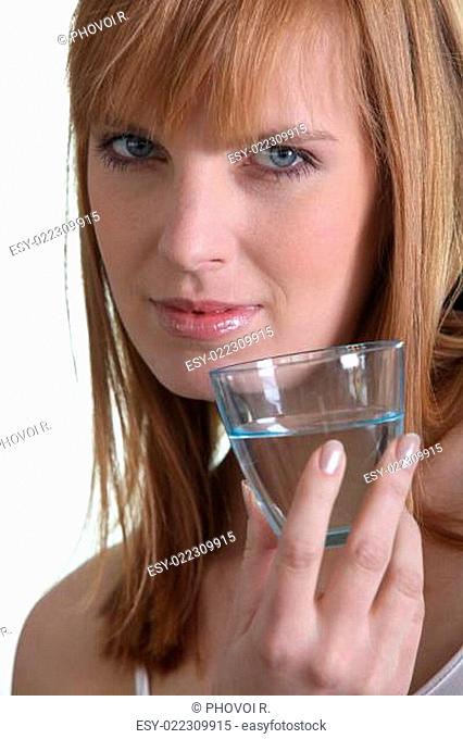 Woman showing a glass of water