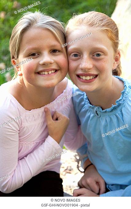 Two Smiling Young Girls in Pink and Blue