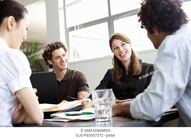 Four businesspeople in an office working