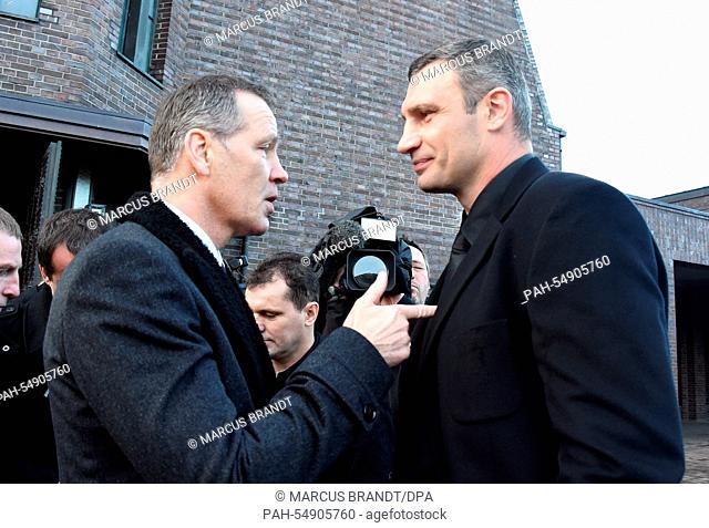 Former boxing pros and world champions Henry Maske (L) and Vitali Klitschko talk to each other after the funeral service of late boxing coach Fritz Sdunek in...