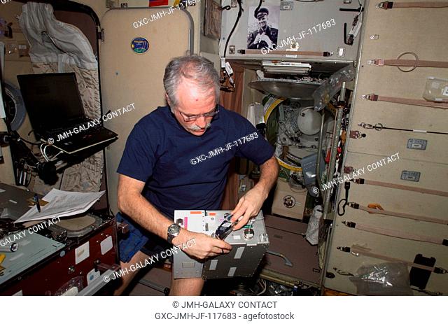 Astronaut John L. Phillips, Expedition 11 NASA Space Station science officer and flight engineer, works with a portion of the Treadmill Vibration Isolation...