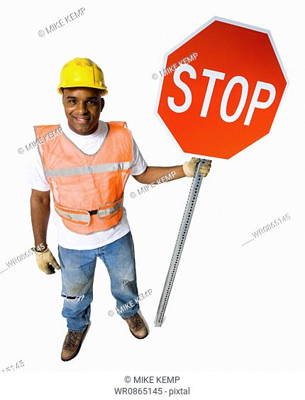 Road worker with stop sign and hardhat