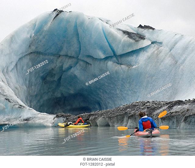 Kayaking beside ice cave at Valdez Glacier, Alaska, USA