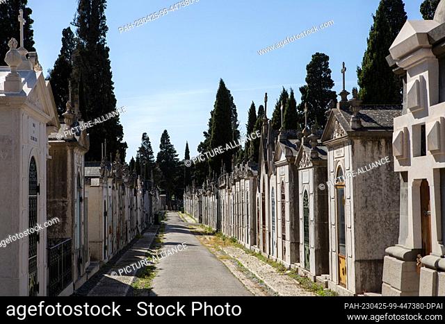 PRODUCTION - 05 April 2023, Portugal, Lissabon: Numerous burial chambers line a path in Lisbon's ""Cemiterio dos Prazeres"" cemetery in the Estrela district