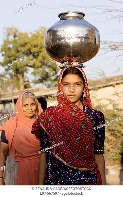 Portrait of Rajasthani woman holding a water pot on her head. Bhenswara. Rajasthan. India