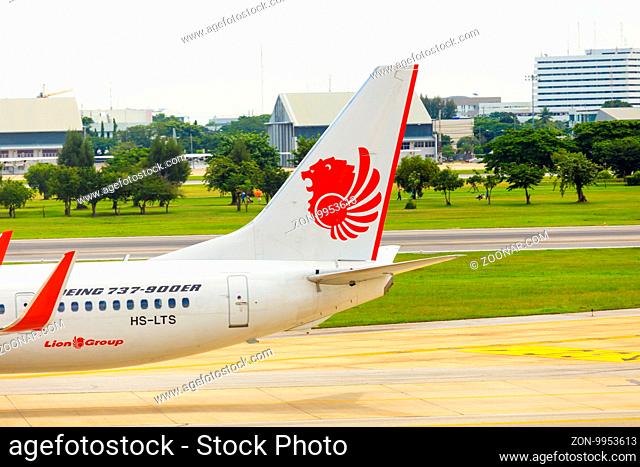 Bangkok, Thailand - November 3, 2015: Tail section of Thai Lion Air airplane taxiing on runway at Don Mueang Airport