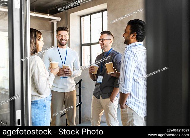 business people drinking takeaway coffee at office