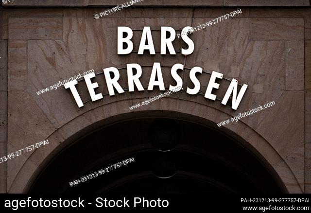 PRODUCTION - 12 December 2023, Saxony, Dresden: Bars and terraces stands above an archway to the Weiße Gasse in the old town