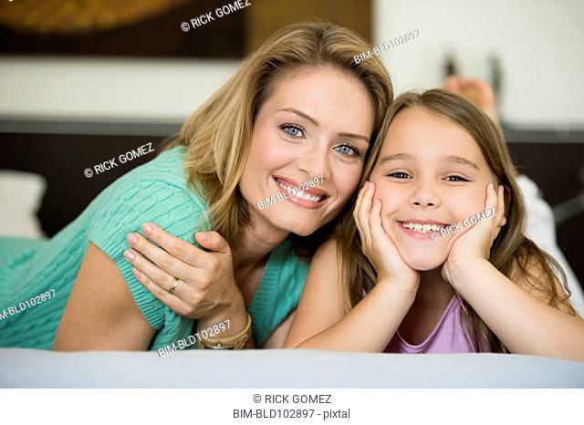 Smiling Hispanic mother and daughter