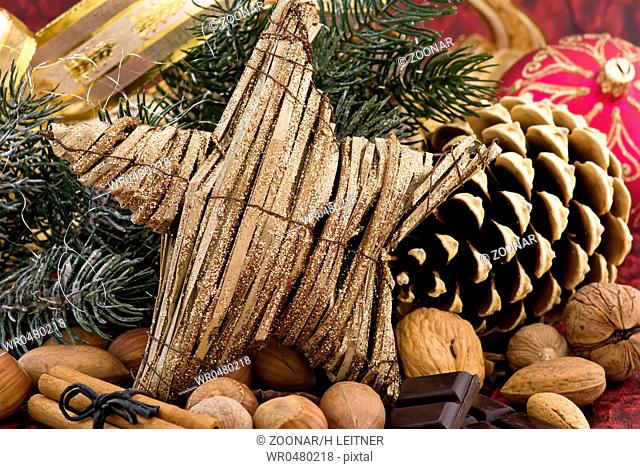 Christmas decoration with a star and pine cone as closeup