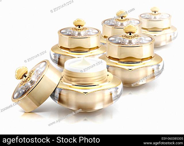 Several golden crown cosmetic jar on white background