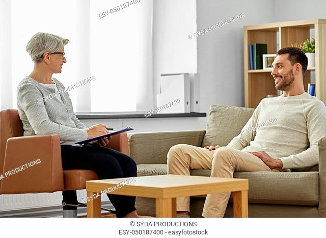 senior woman psychologist and young man patient