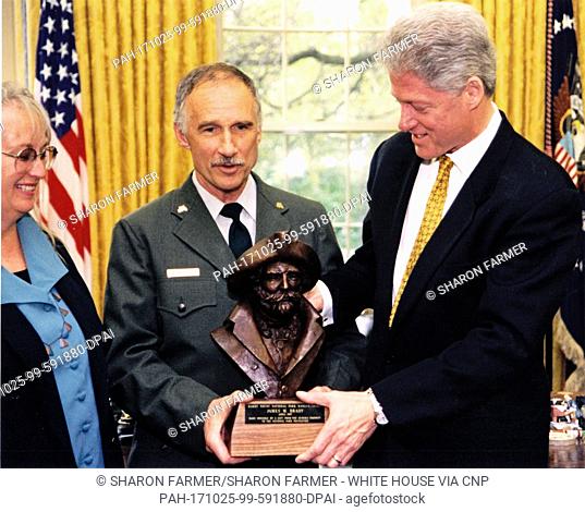 United States President Bill Clinton awards James M. Brady the Harry Yount National Park Ranger of the Year Award in the Oval Office of the White House in...