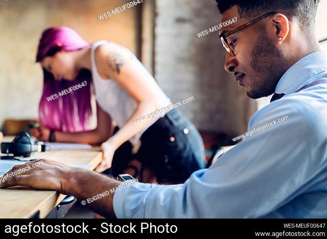 Creative business people working at table in loft office