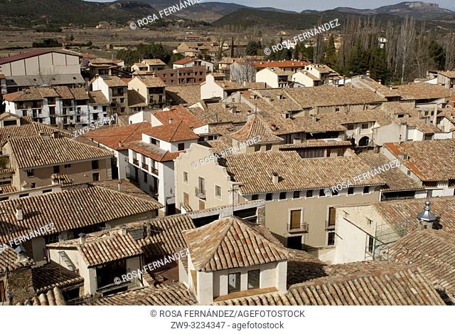 View of Rubielos de Mora, traditional buildings with arabic tiles at the roof, Mudejar church and rural landscape, province of Teruel, Aragón Region, Spain