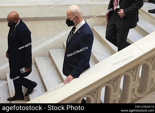 President Joe Biden walks down a set of stairs at the United States Capitol in Washington, DC on January 13, 2022 after he met with the Senate Democratic Caucus...