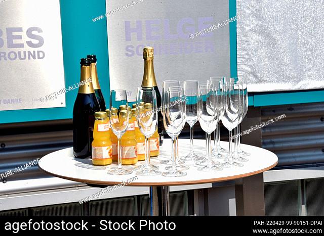 28 April 2022, North Rhine-Westphalia, Cologne: Champagne bottles, champagne glasses and orange juice are on a bar table Photo: Horst Galuschka/dpa