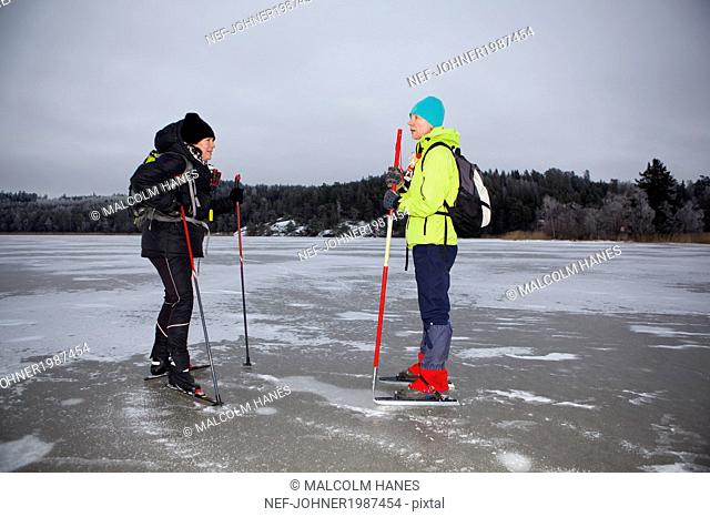 Two women ice-skating