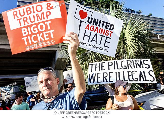 Florida, Miami, protesters, signs, protest, 2016 presidential campaign, Rubio Trump, MoveOn.org, immigration, man, woman, holding