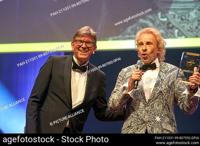 30 October 2021, Hessen, Frankfurt/Main: Publicist Wolfram Weimer (l) honors Thomas Gottschalk with the title ""Living Brand"" at the Brand Gala
