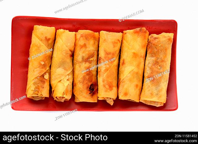 lumpia Semarang or Spring Rolls containing bamboo shoots and chicken on red plate at white background