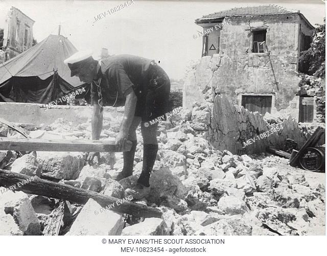 A scout in the ruins of Argostolion, Kefalonia, Greece. Four earthquakes hit the island in August 1953, destroying many buildings; the scouts helped with...