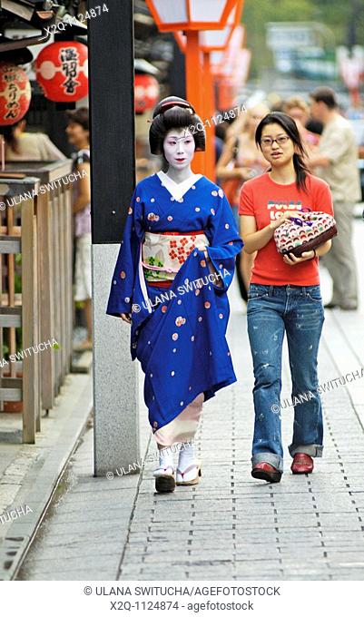 A geisha geiko and her assistant stroll to an appointment in Gion Kyoto Japan