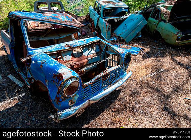 Wreck of a destroyed and abandoned car. Environmental pollution and need for recycling