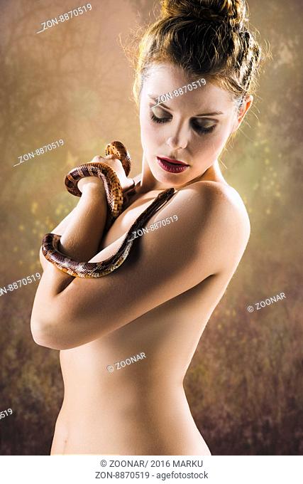 Portrait of a girl with red corn snake