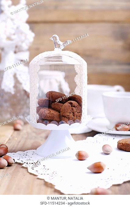 Crispy chocolate and hazelnut biscuits under a glass cloche